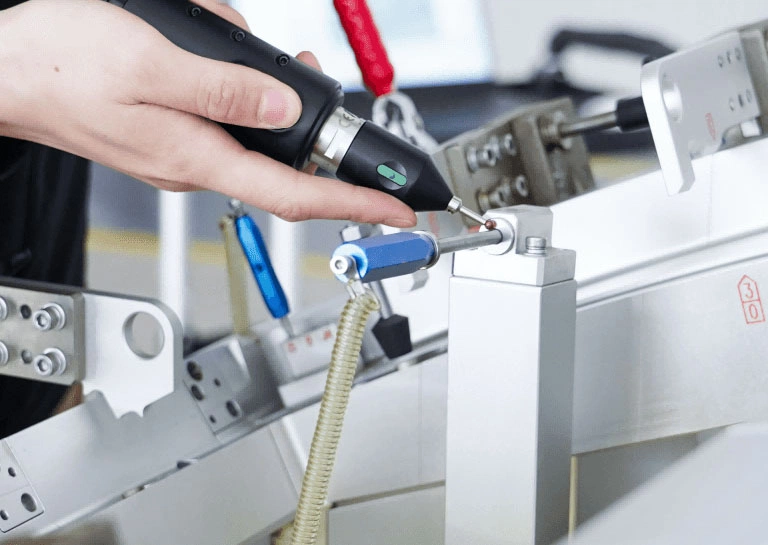 Technician using a Scanology NimProbe optical probing system to measure reference holes on a large machined metal component.